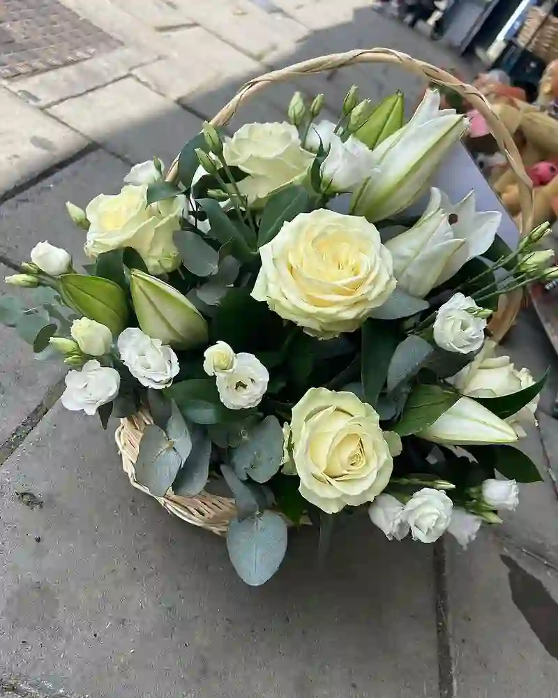 A white rose and lisianthus sympathy basket