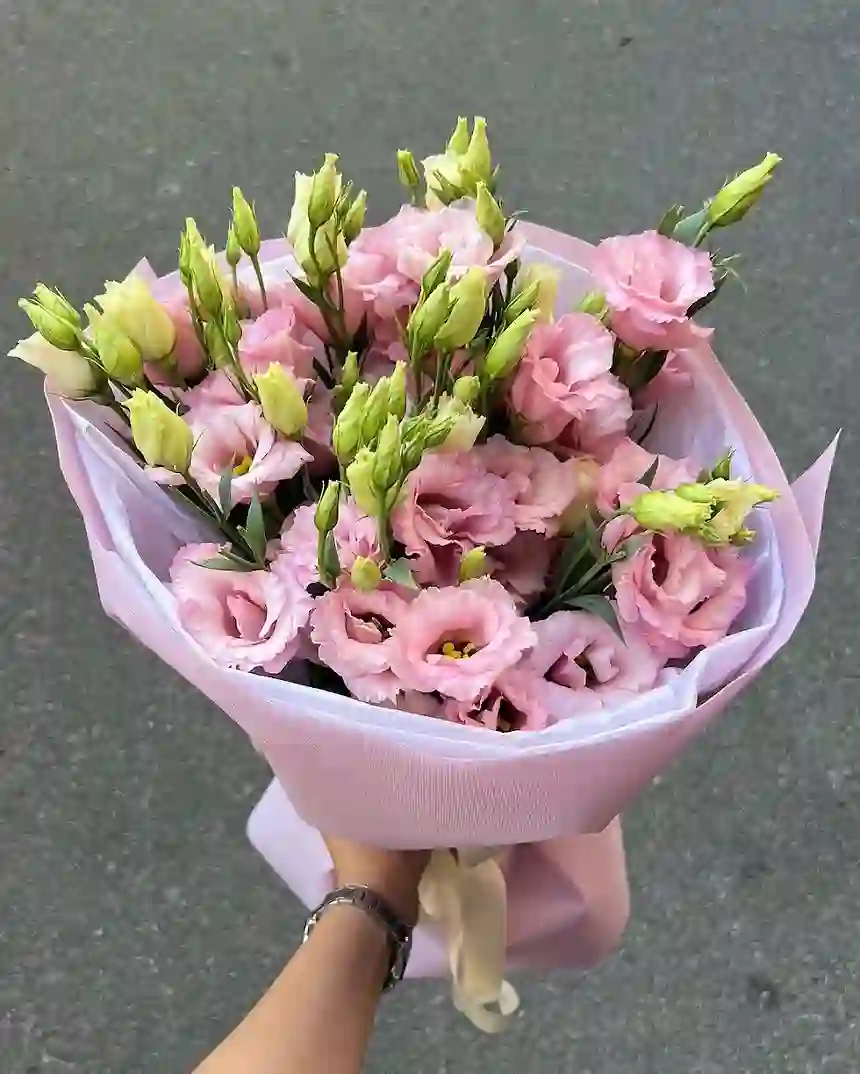 A hand-tied pink bouquet arranged by BloomHaus